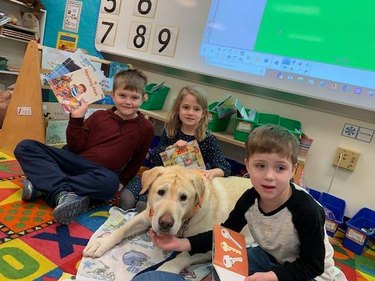 dog helping child read