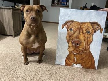 dog sitting next to its custom portrait.