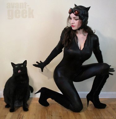 Cosplayer and black cat