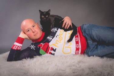 Christmas card photo of a guy and his cat