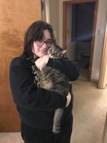 woman cradles cat