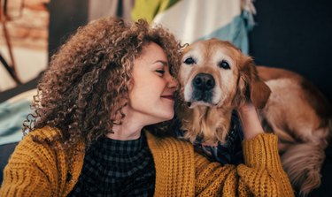 Woman cuddling with her dog