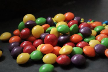 colorful small candies on black background