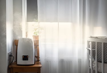 air purifier in room next to window
