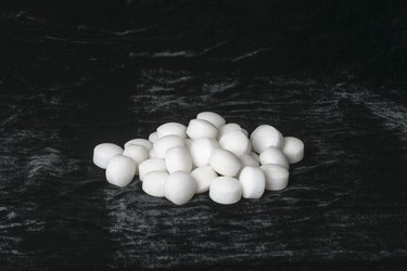 White naphthalene balls on black velvet