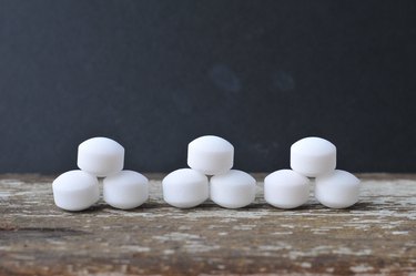 High Angle View Of Mothballs On Wooden Table