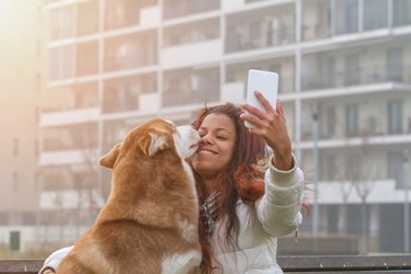 Young woman and her dog doing selfie