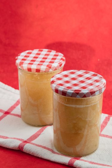 canned applesauce on white and red cloth