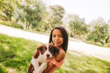 Cute young African-American long haired brunette girl cuddling a