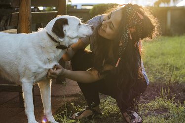 Smiling Young Woman Embracing a Dog