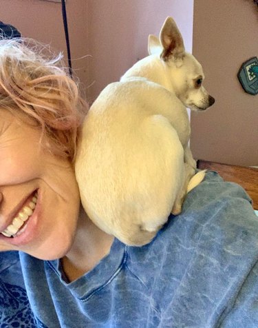 Woman with small dog sitting on her shoulder