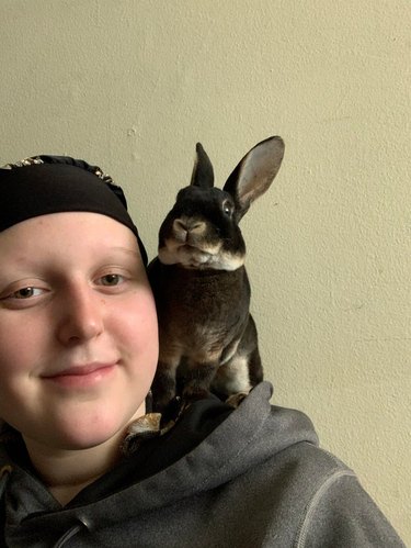 Person with rabbit sitting on shoulder