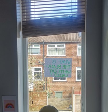 A woman posts sign in window for neighbor's cat.