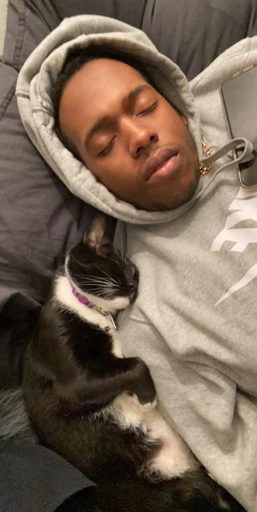 cat sleeps next to man