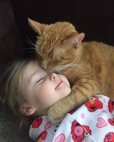 black cats cuddles with girl