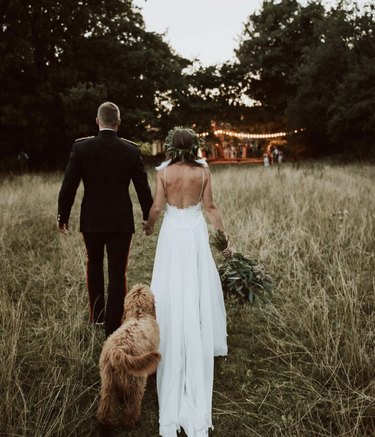 dog trailing bride and groom
