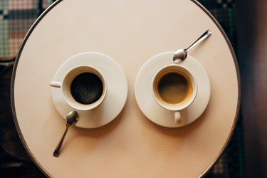 Directly above view of two coffee cups on the table in the cafe