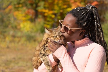 Beautiful teen girl hugging her new pet adopted friend