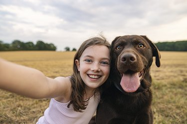 Girl taking a selfie with her pet dog