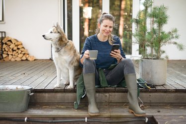 woman working in the garden ( house, dog, telephone)