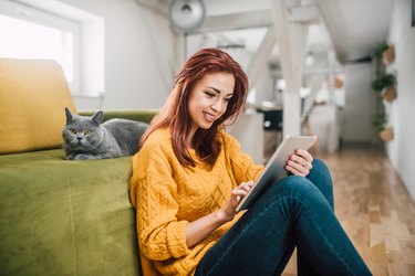 Woman using digital tablet and smiling