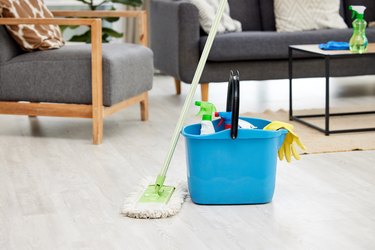 Shot of a bucket of cleaning supplies in an empty living room