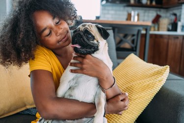 Girl and a dog at home.