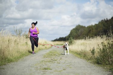 Woman running with dog