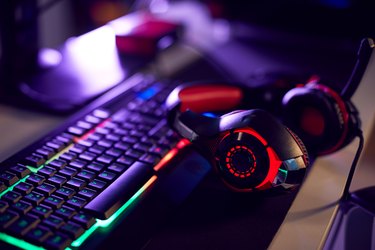 Still Life Of Computer Gaming With Headset Lying On Keyboard