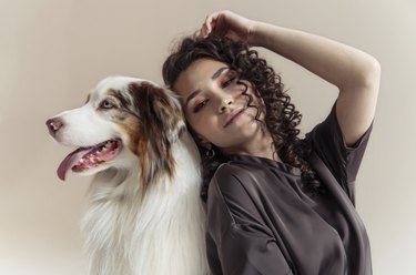 Woman and her dog posing together