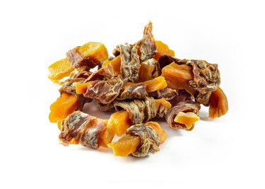 sweet potato and dried meat twists, dog treats on white background
