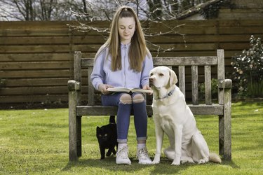 Girl in the garden with her pets