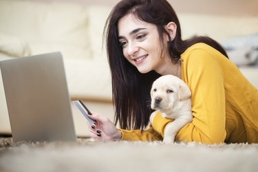 Young woman with puppy at home