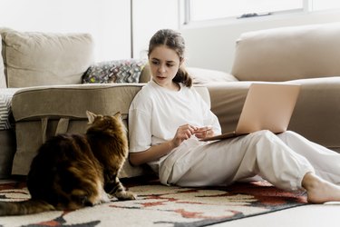 Teen Girl Plays with a Cat