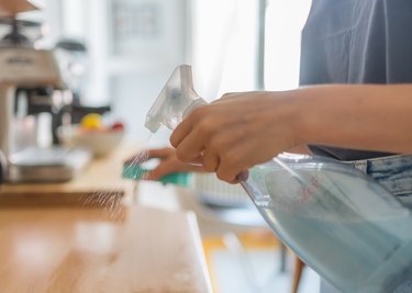 woman cleans kitchen counters