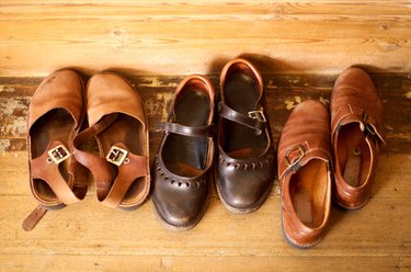 Three brown pairs of leather shoes side-by-side