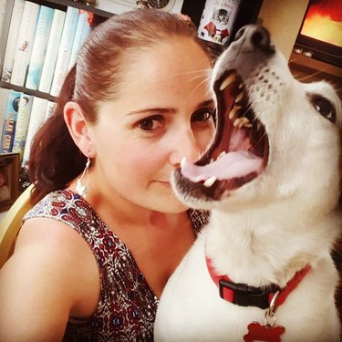 dog excited to photobomb woman's photo