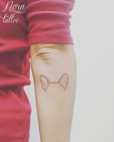 Tattoo of her dogs ears located on the inner forearm