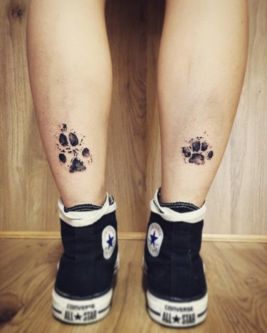 A tattoo of muddy paw prints.