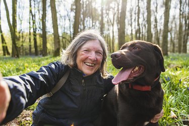 woman takes selfie with smiling dog