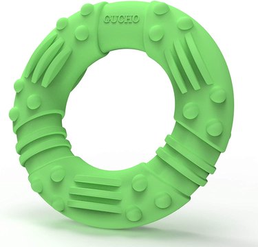 Green ring dog toy for aggressive chewers made of durable rubber.