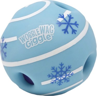 Wobble Wag giggle ball that's light blue with white stripes and dark blue snowflakes on it.