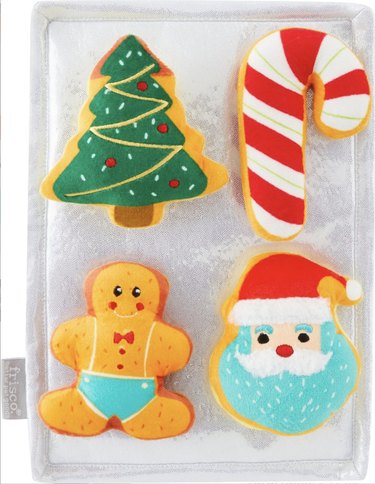 Interactive dog toy shaped like a baking sheet with plush Christmas cookies stuck onto it with velcro.