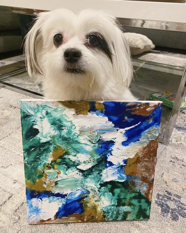 small white dog with their painting.