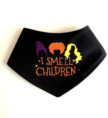 Black bandana with the hair silhouttes of the Sanderson sisters and the words "I Smell Children."