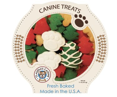 Gourmet dog treats shaped like Christmas trees and paw prints in a decorative box that lets you see what's inside.