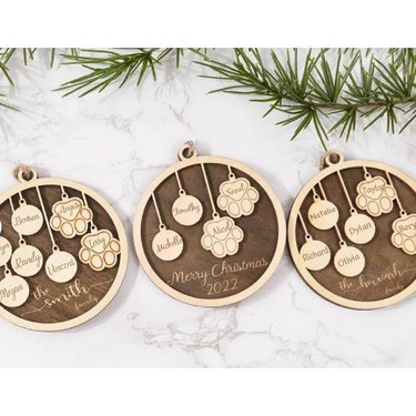 Engraved wood ornaments with the names of family members and pets