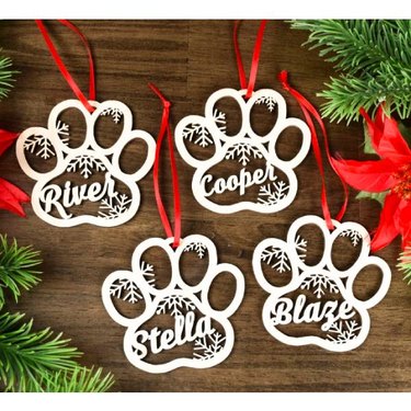 Laser cut ornaments in paw print designs with the pet's name