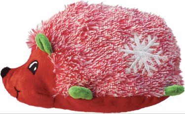 Red hedgehog plush toy with green ears and feet and snowflakes on his back.