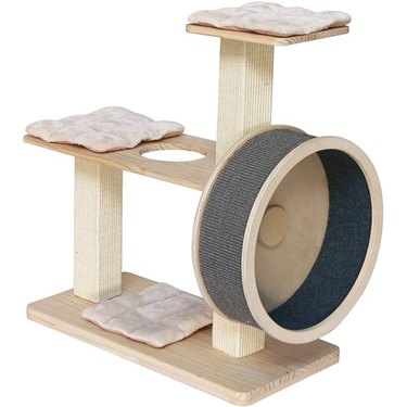 A wooden cat tree with three levels of cushioned perches and a mini cat wheel on the side lined with sisal.